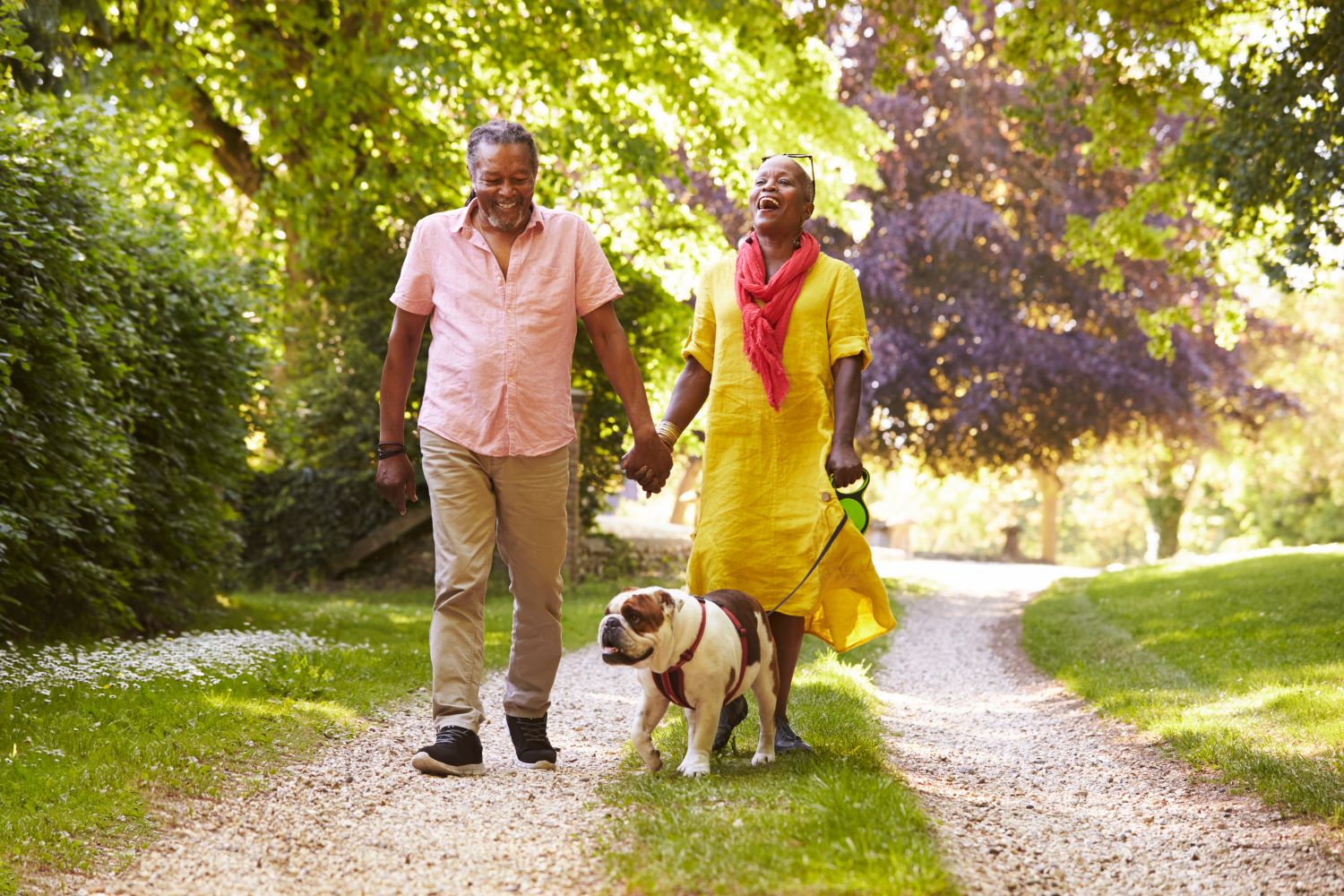 man and woman walking dog