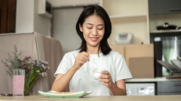 woman at table with drink for hydration