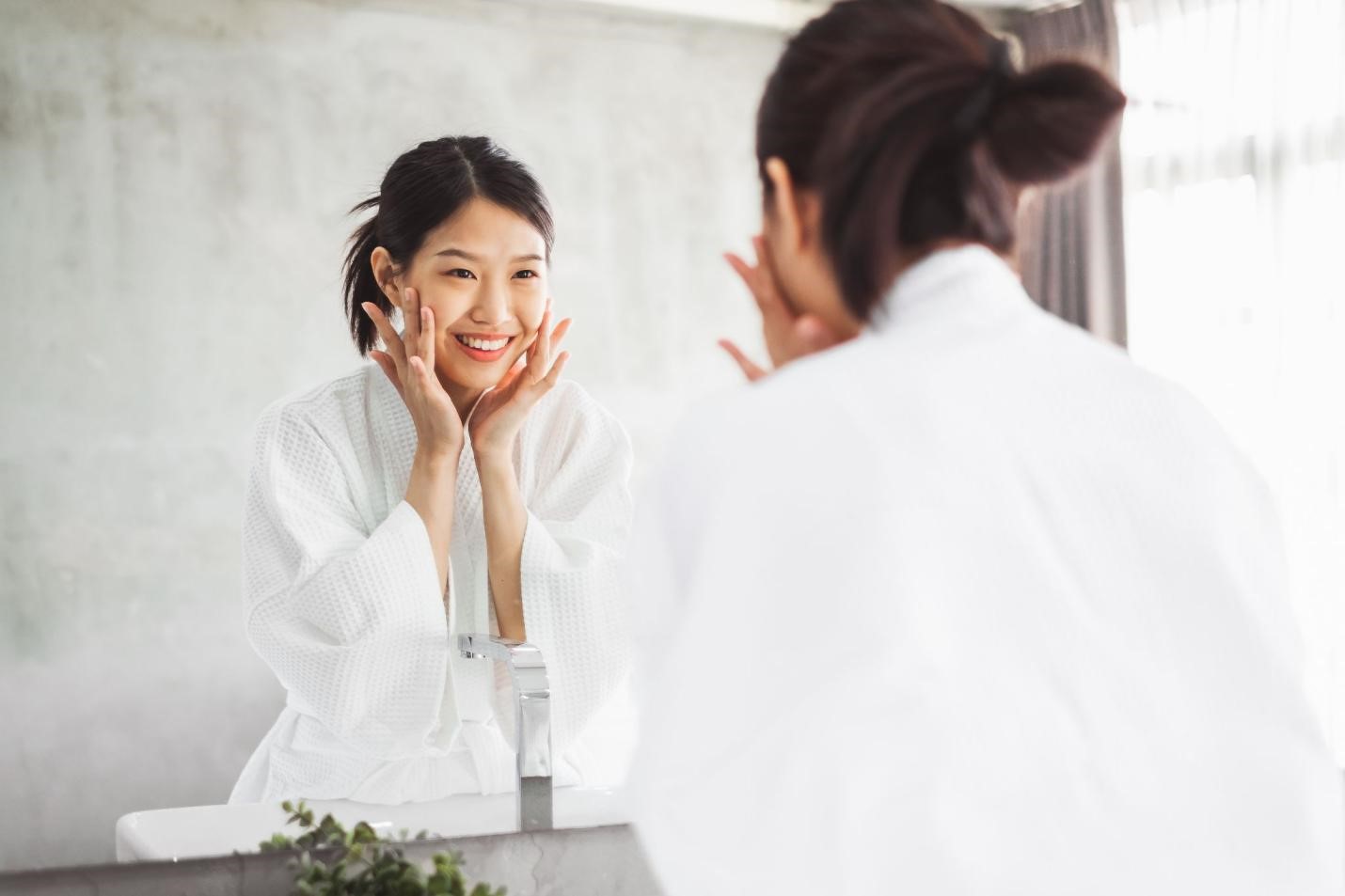 woman looking in mirror