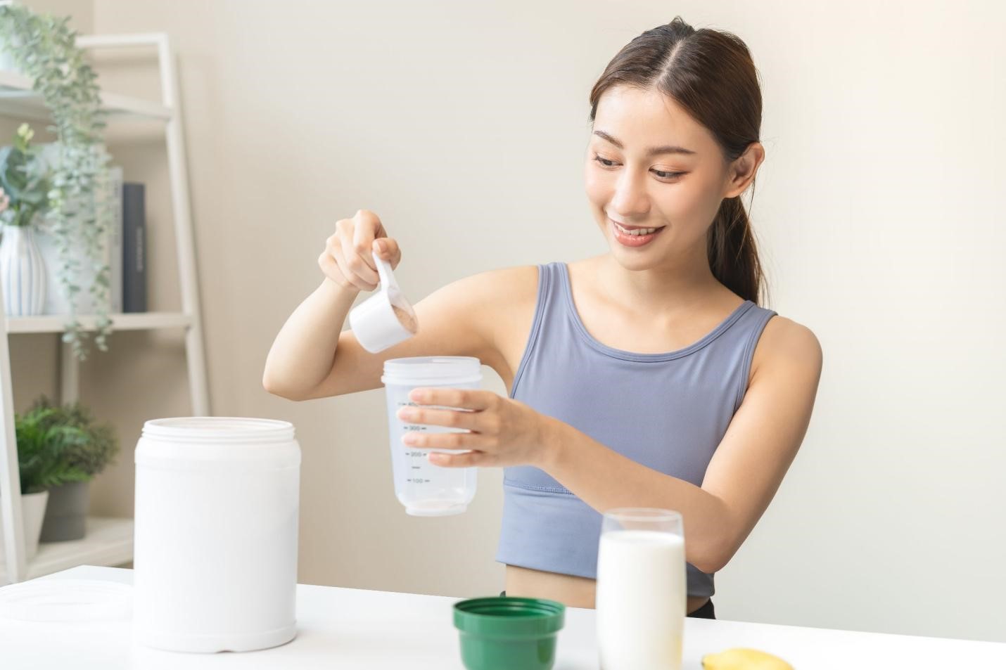 woman making protein shake