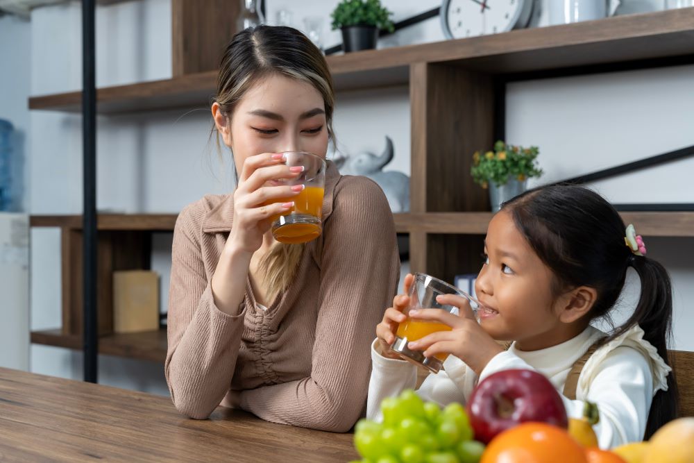 mom and daughter drinking vitamin c