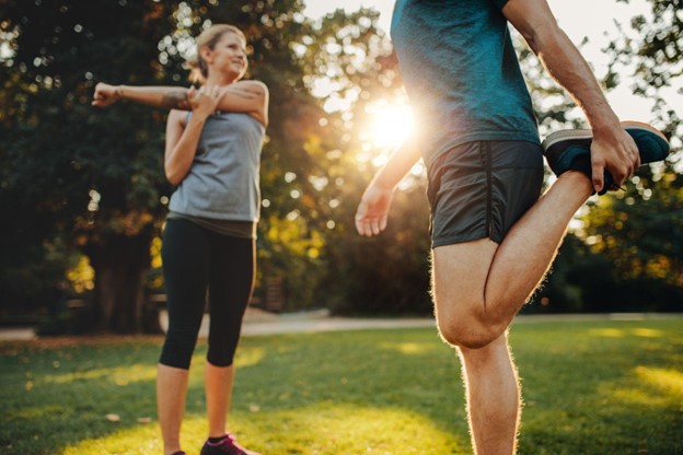 man and woman stretching
