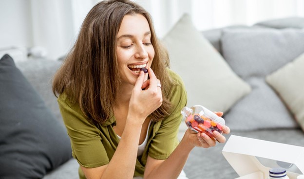 woman taking gummy supplement
