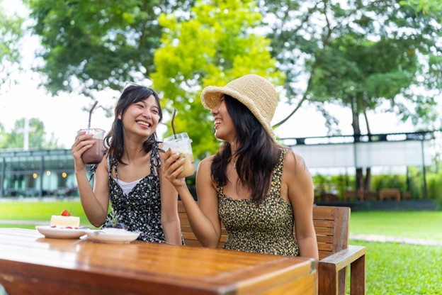 two girls outside at table