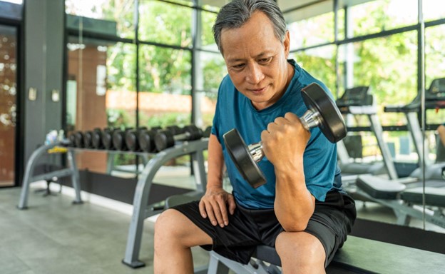 senior man lifting weights