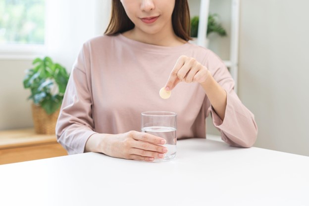 woman putting tablet in water