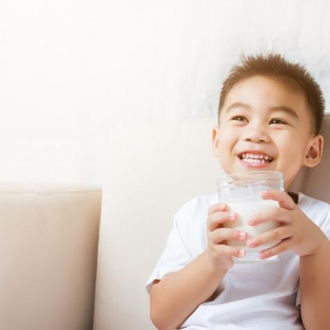 little boy with glass of milk