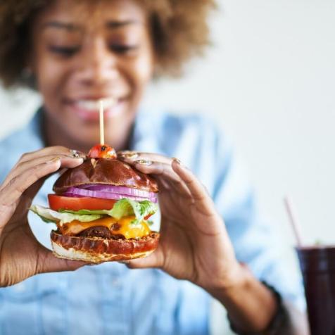 woman eating cheeseburger