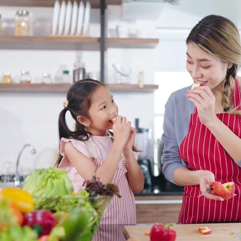 woman and child eating apple