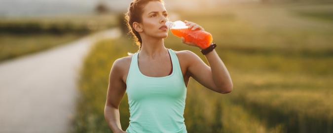 woman drinking beverage on walk