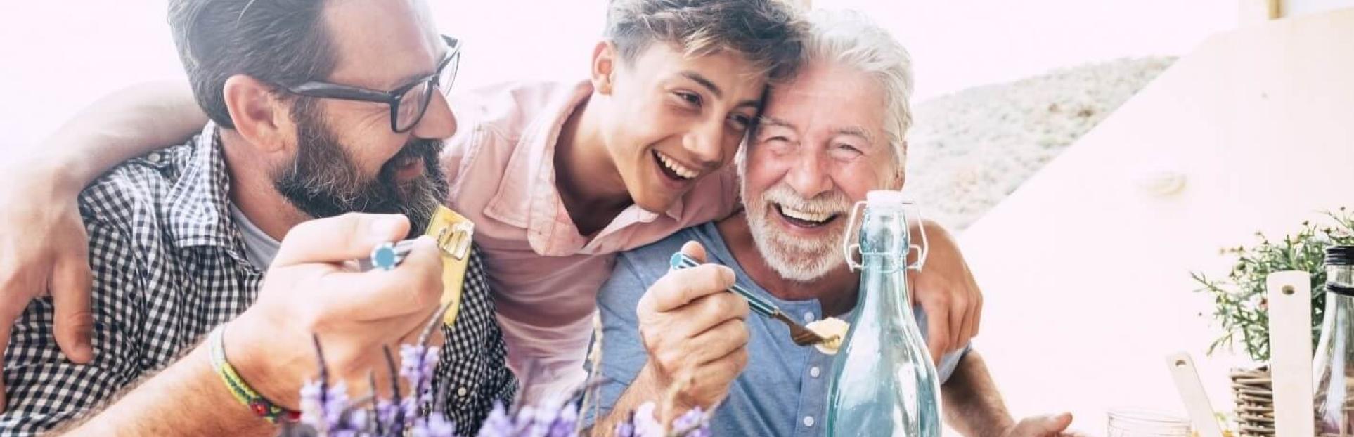 3 men laughing and eating