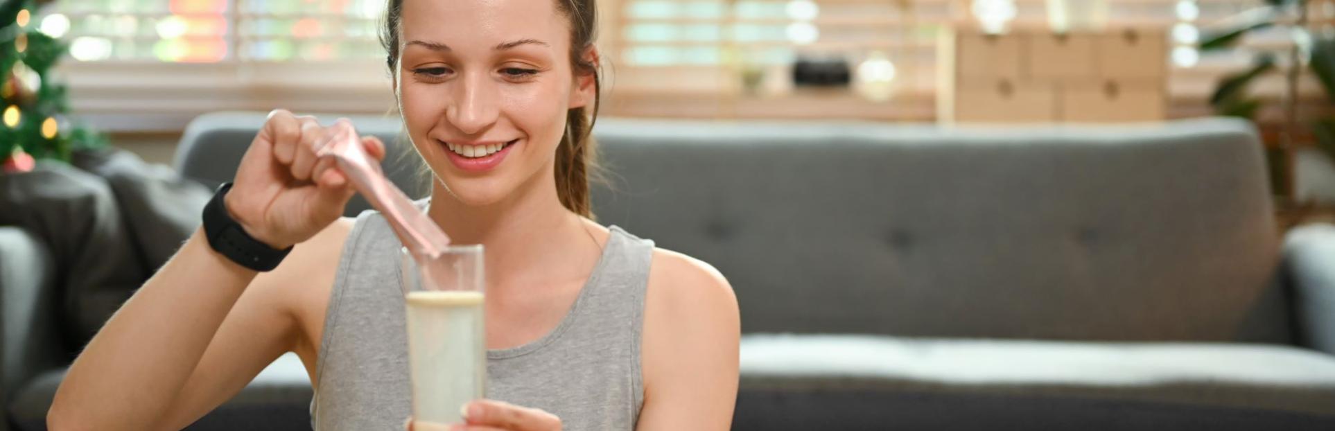 woman pouring powder mix into water
