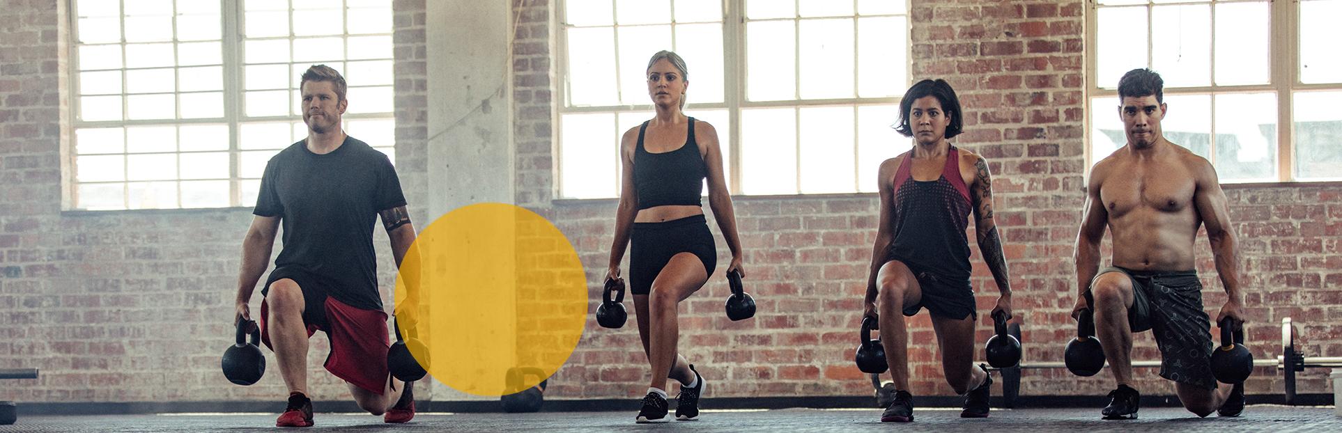 men and woman with kettle bells 