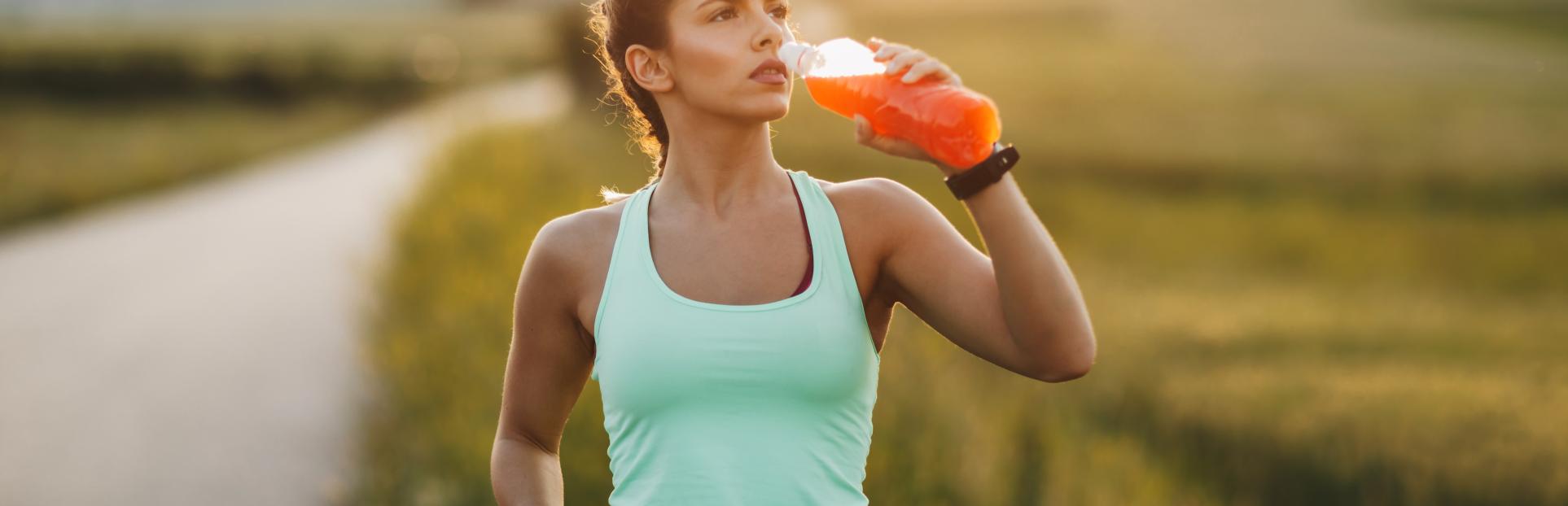 woman drinking beverage on walk