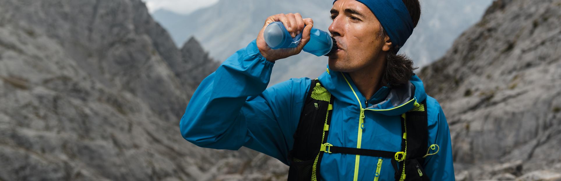 man hiking drinking beverage