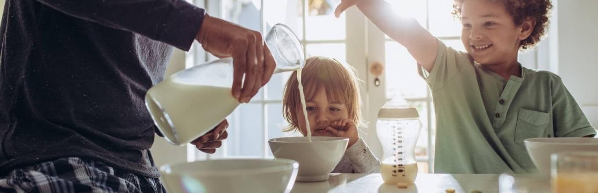 dad and kids pouring milk