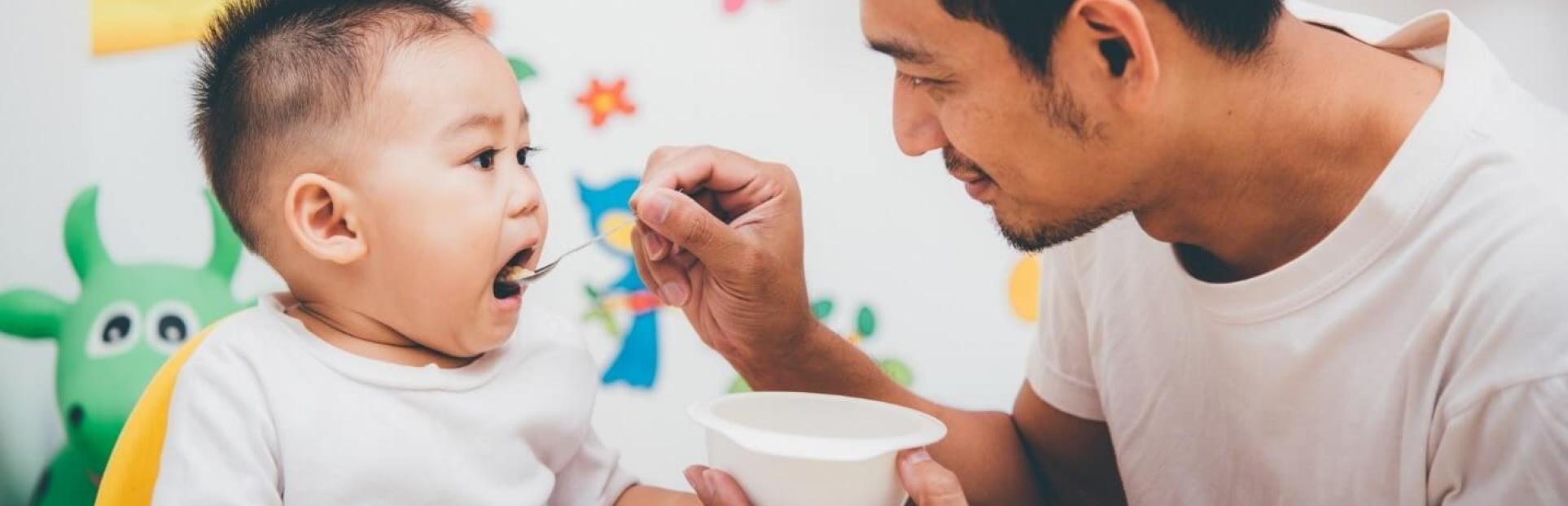 dad feeding baby