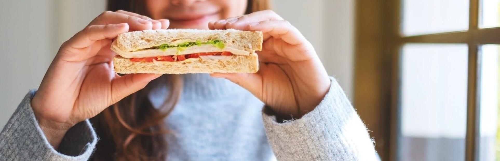 girl holding sandwich