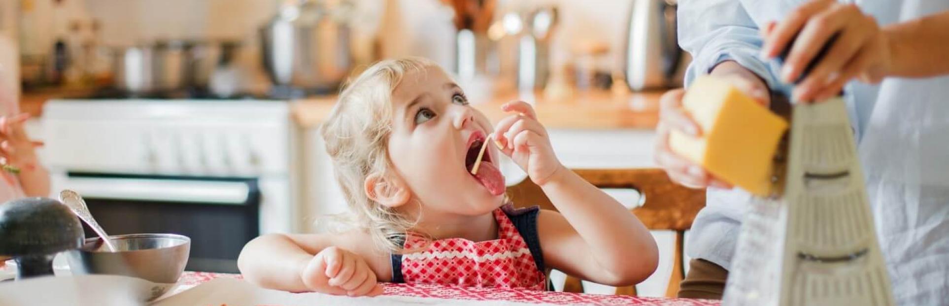 little girl eating cheese