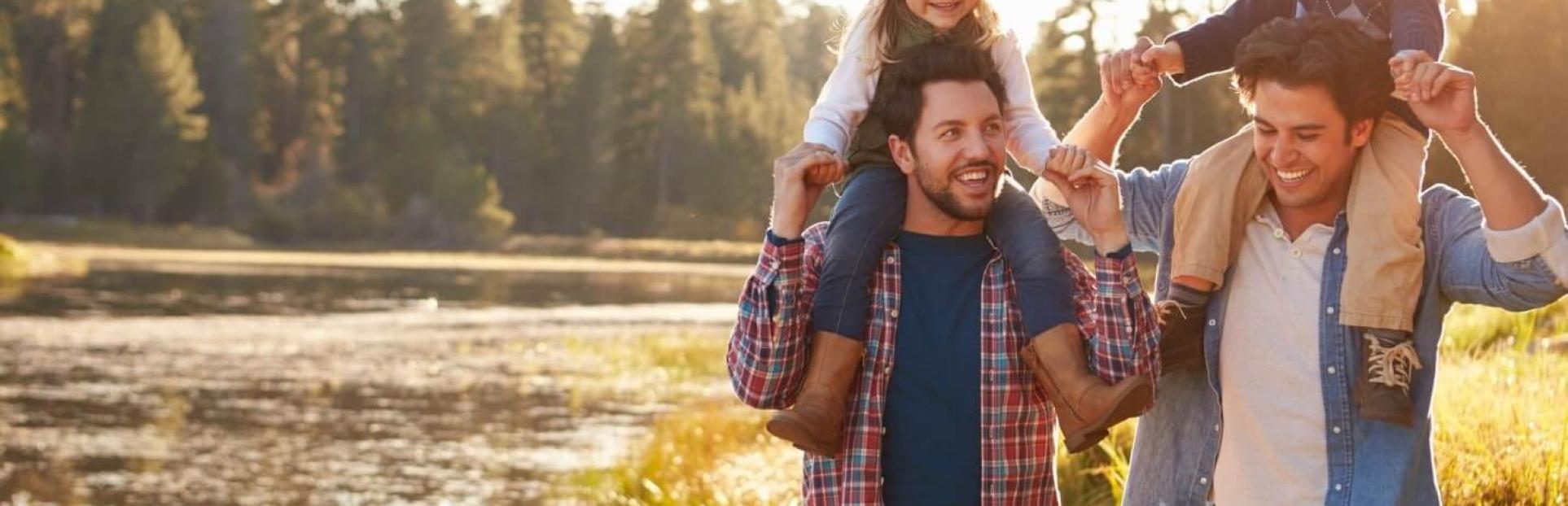 parents with kids on shoulder