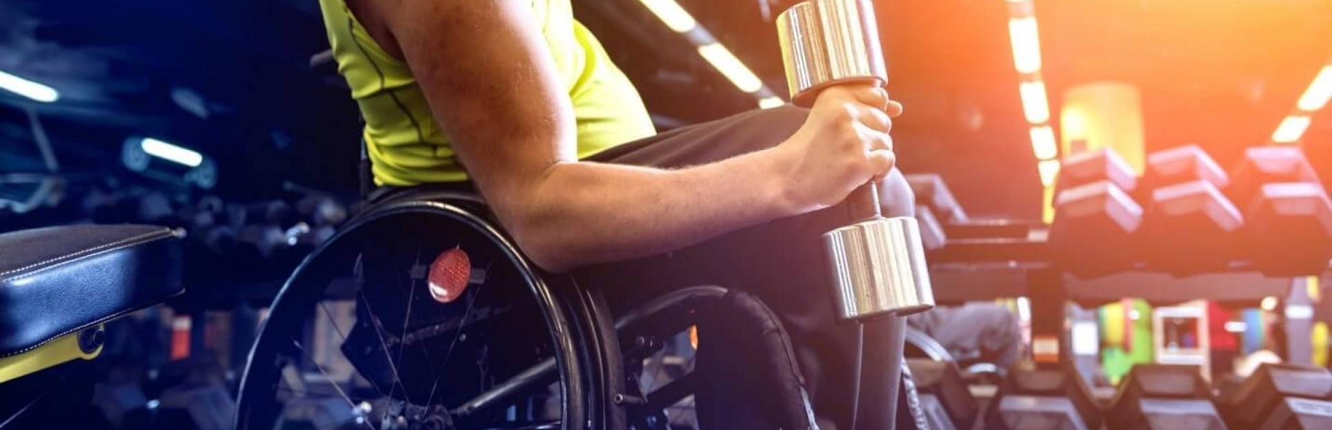man in wheelchair lifting weight