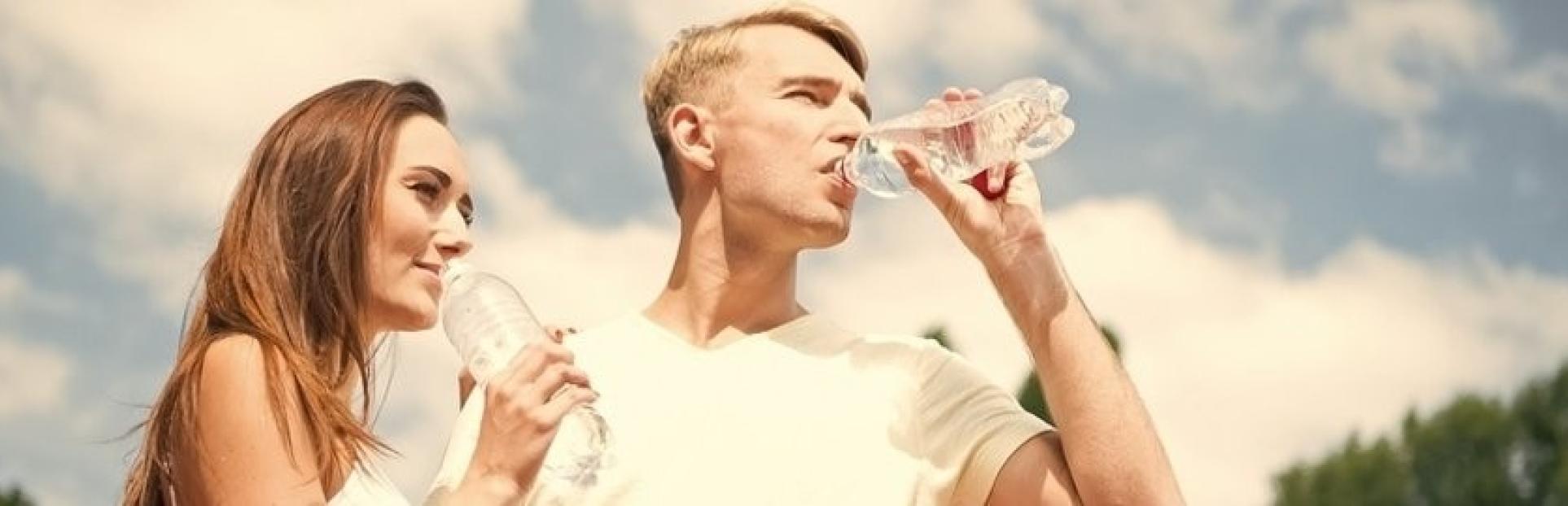 man and woman drinking water