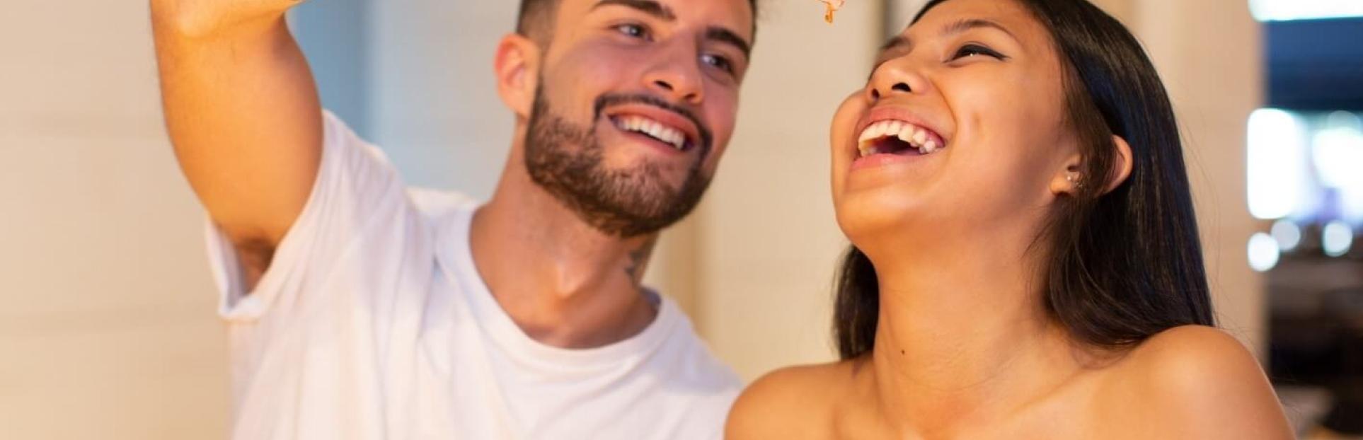 man feeding woman cheese