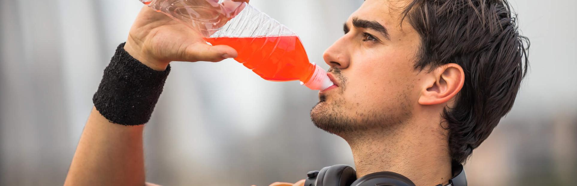 man drinking red beverage