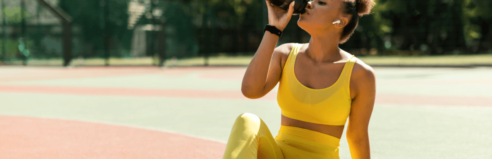 woman drinking water after workout