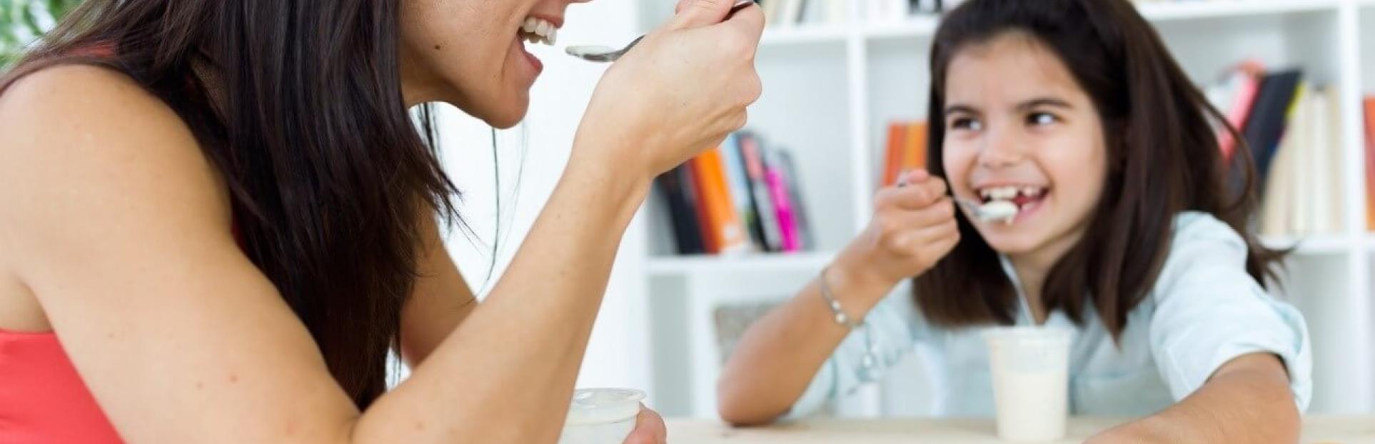 mom and daughter eating yogurt