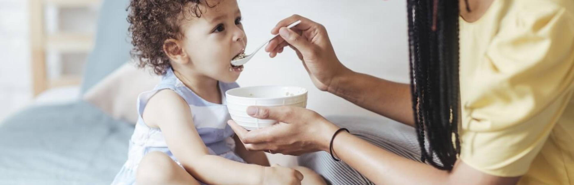 mom feeding toddler