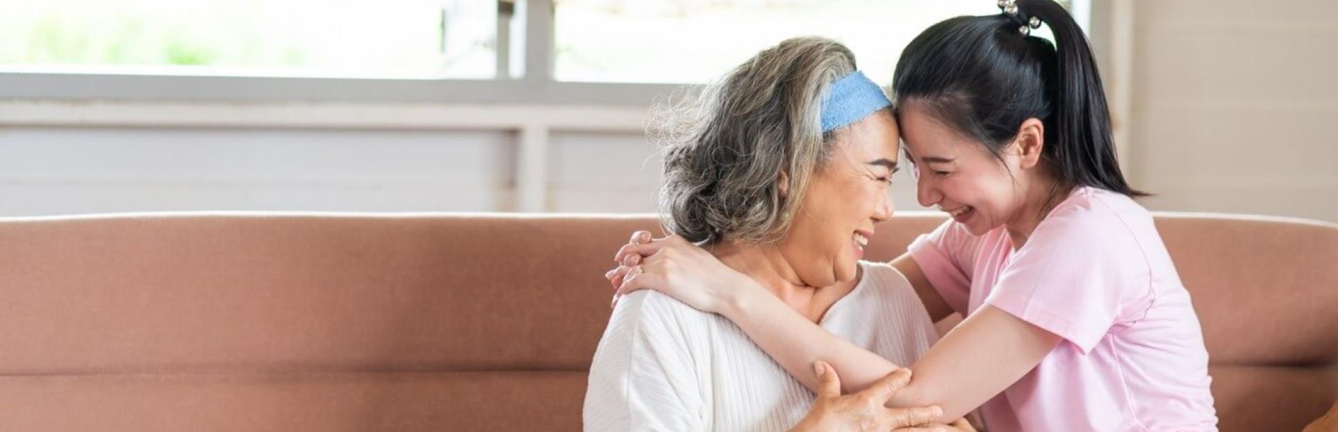 two asian women hugging