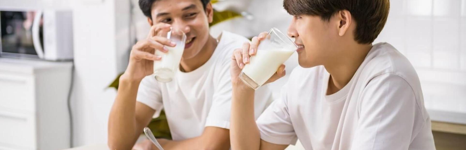 two men drinking milk
