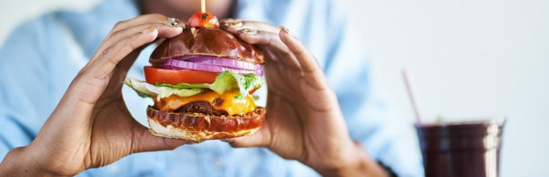 woman eating cheeseburger