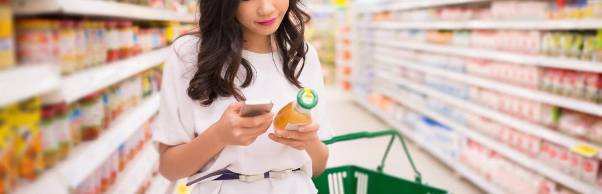 woman looking at juice in store