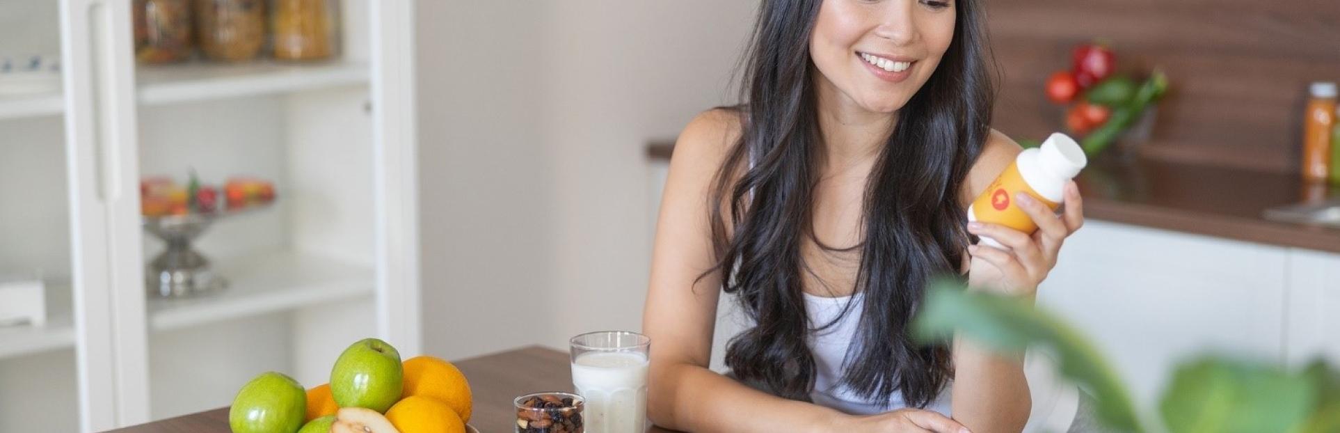 woman at table with supplements