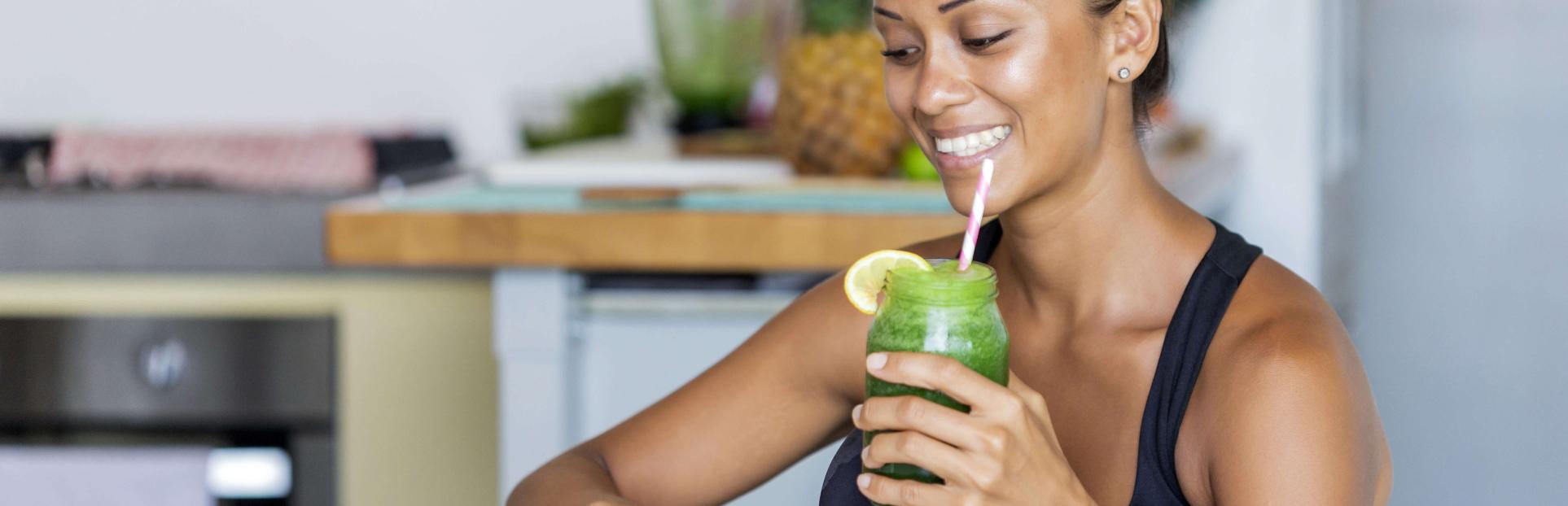 woman drinking green juice