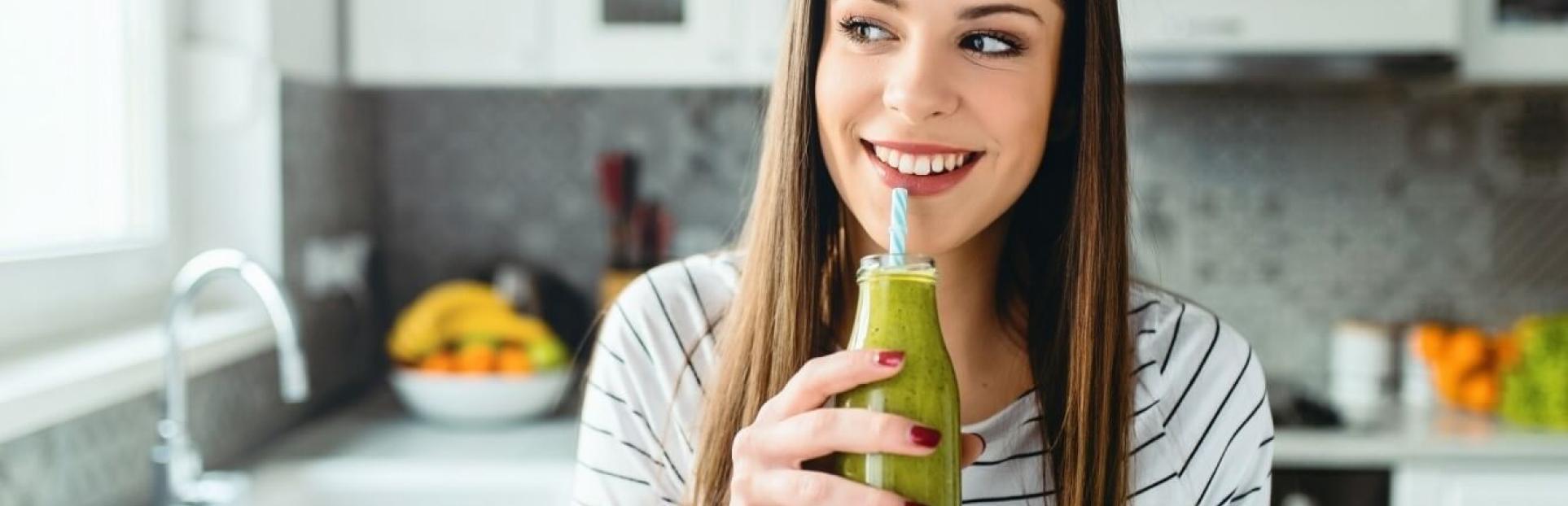 woman drinking green juice