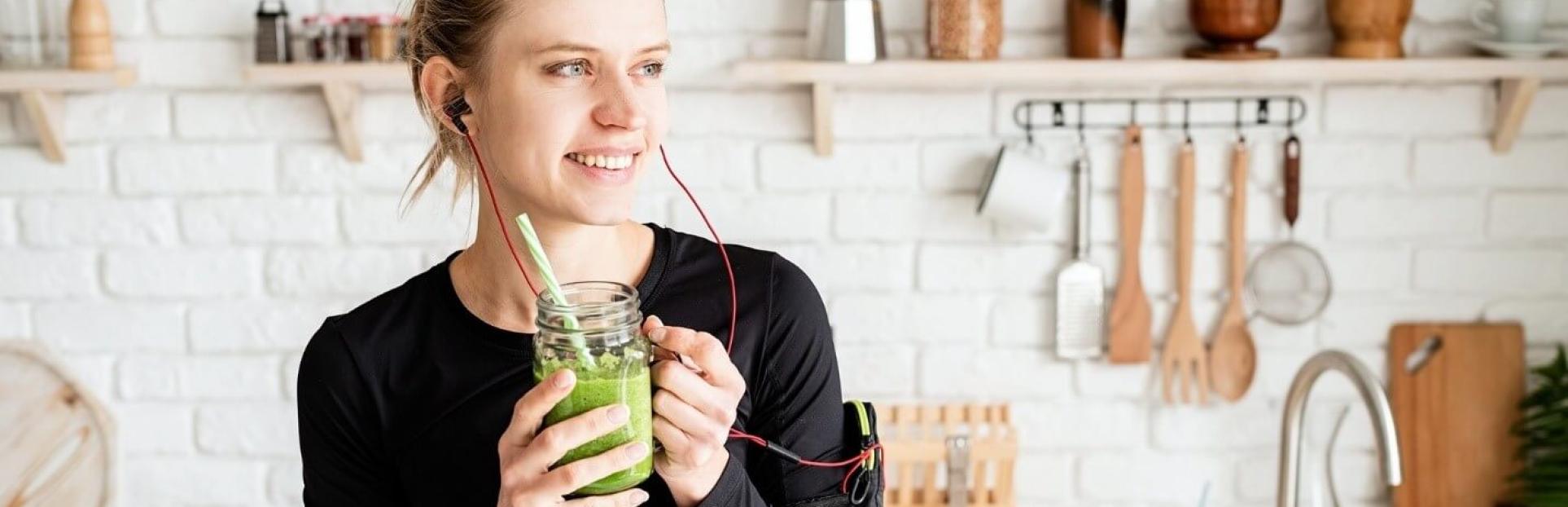 woman drinking green juice