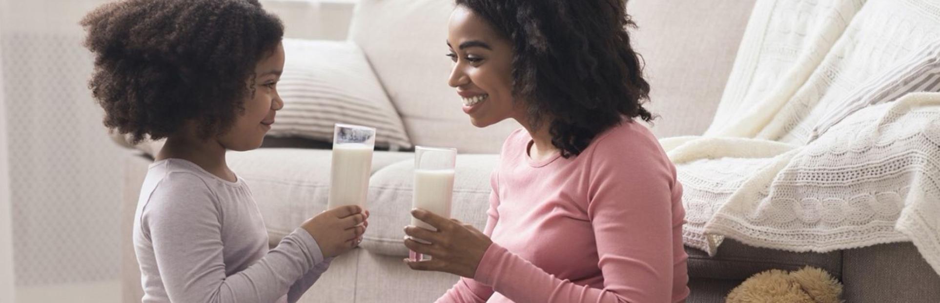 woman drinking milk with kid