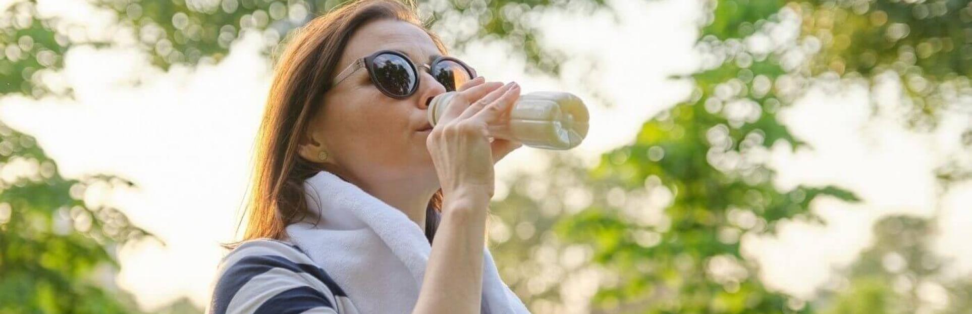 woman drinking shake after working out