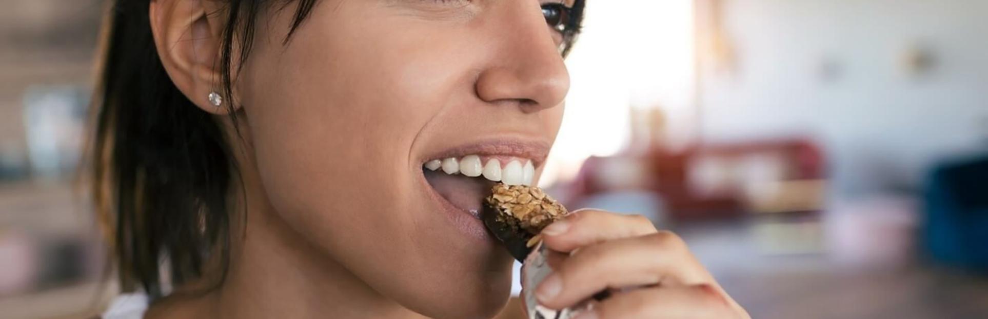 woman eating bar