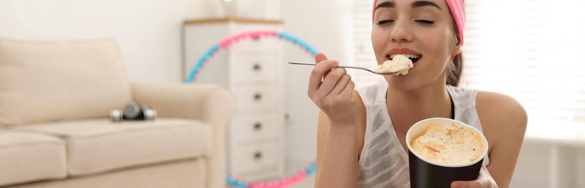 woman eating ice cream on exercise ball