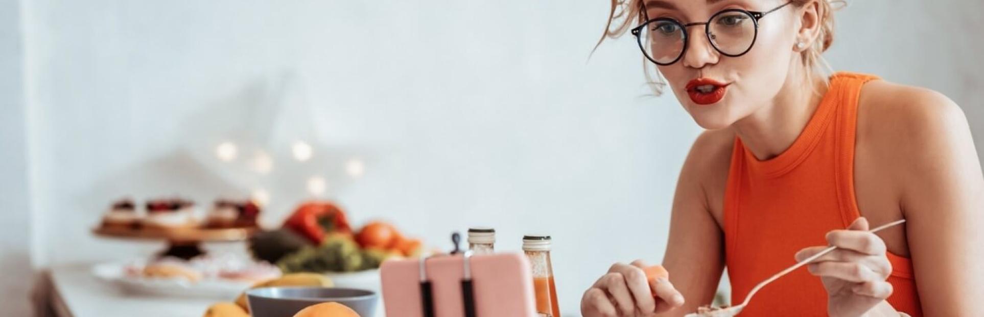 woman snacking and talking on phone