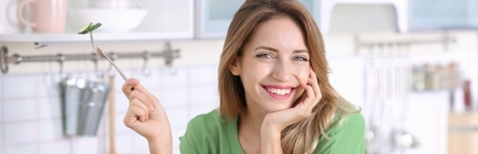 woman holding a fork with cucumber