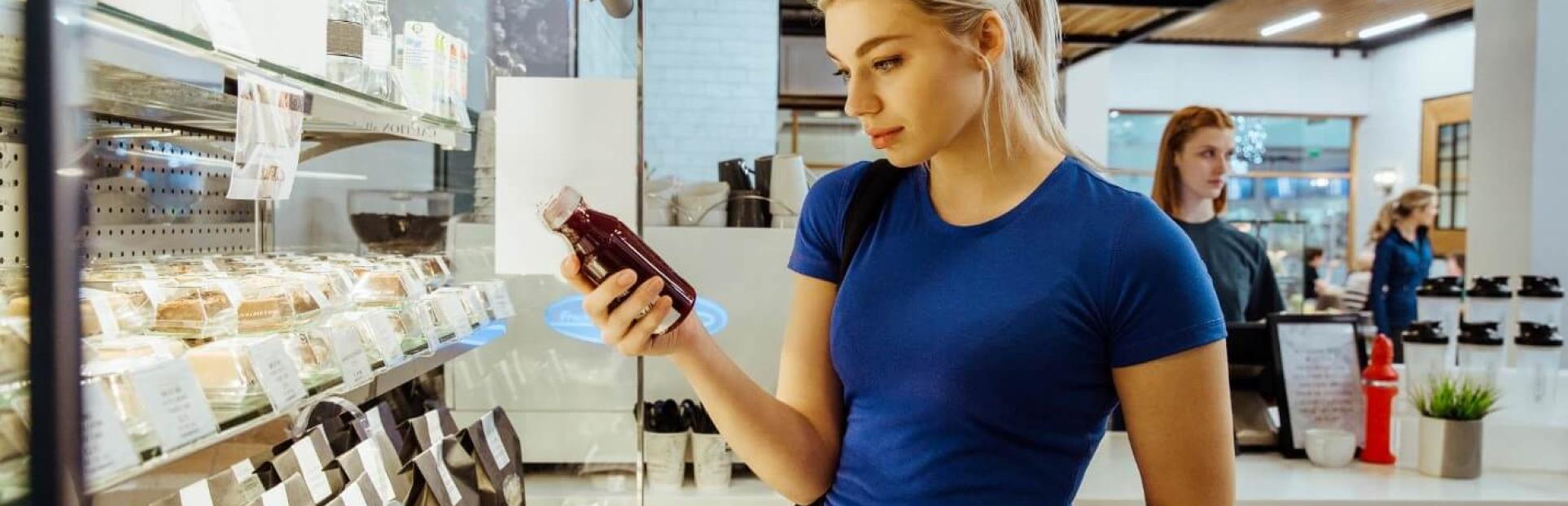 woman looking at juice in store