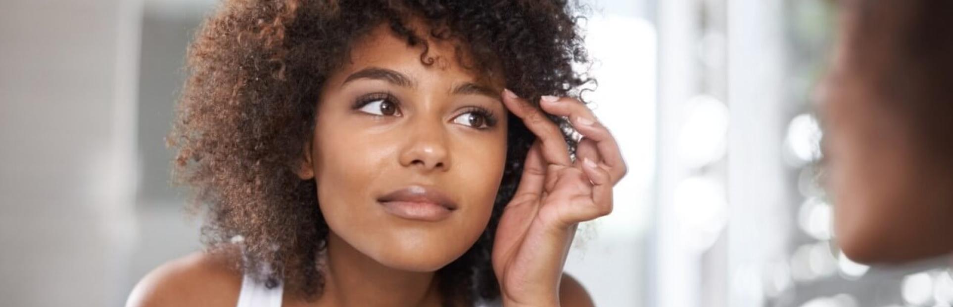 woman looking in mirror