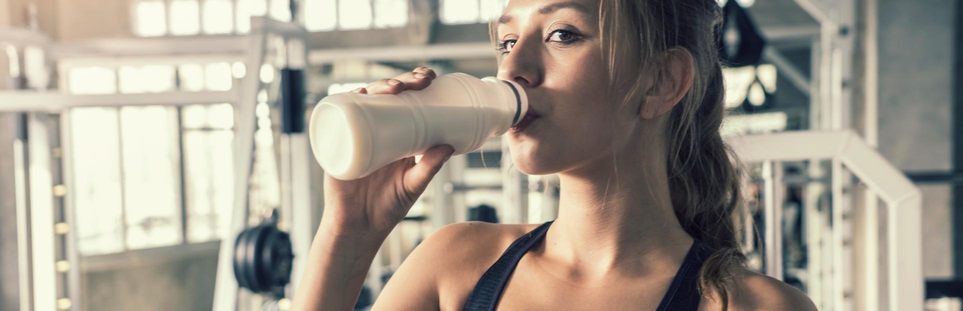 woman drinking beverage after workout