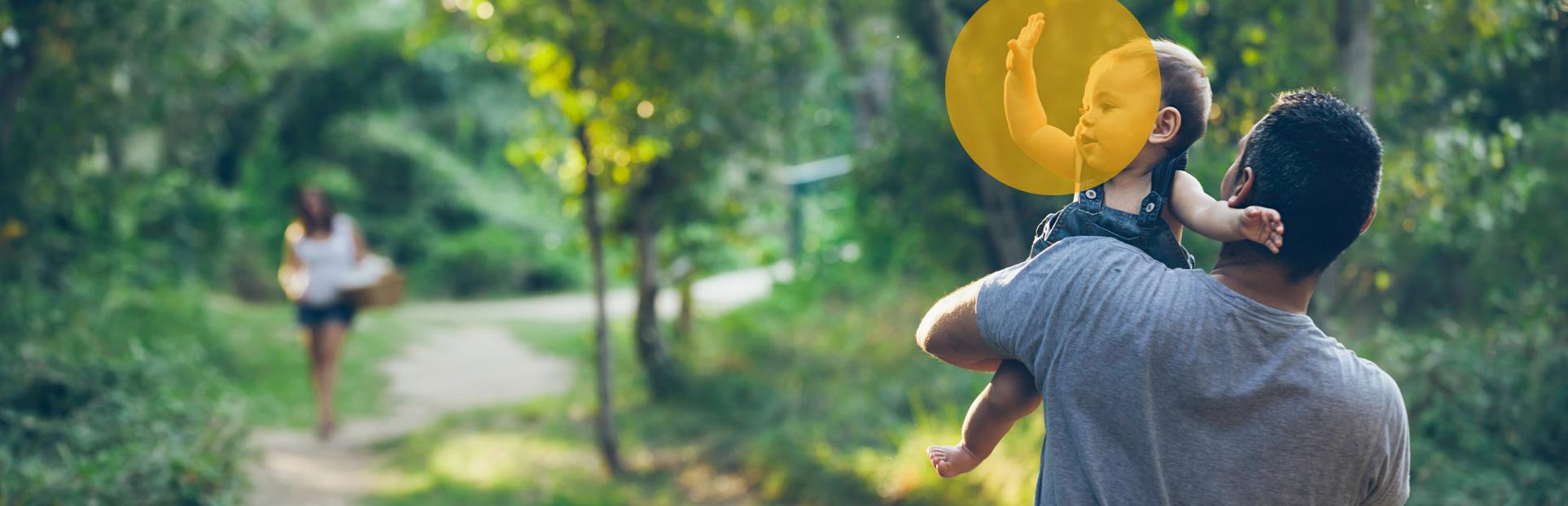 Man with waving child in woods