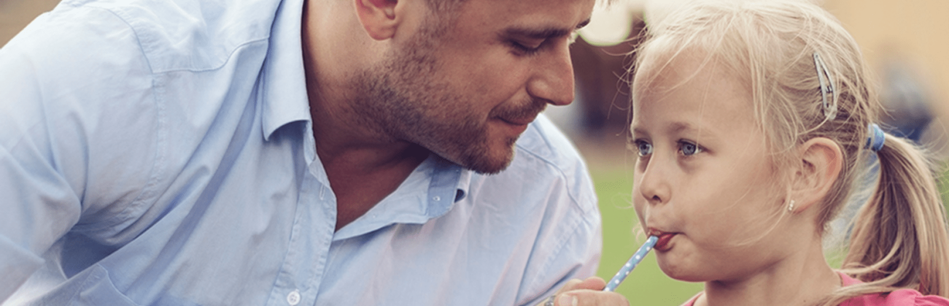 father and daughter drinking a juice